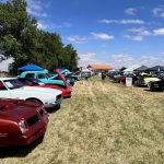 Front ends of vehicles parked at the Chiefs Car Show 2025