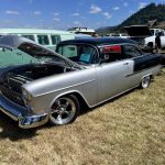 Classic car with hood open to expose custom engine build