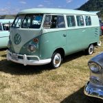 Volkswagen bus in teal and seafoam and sitting on white walled tires