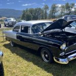 Classic car with the hood open to reveal engine
