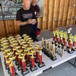 Man standing in front of trophies at the Chiefs Car Show 2025